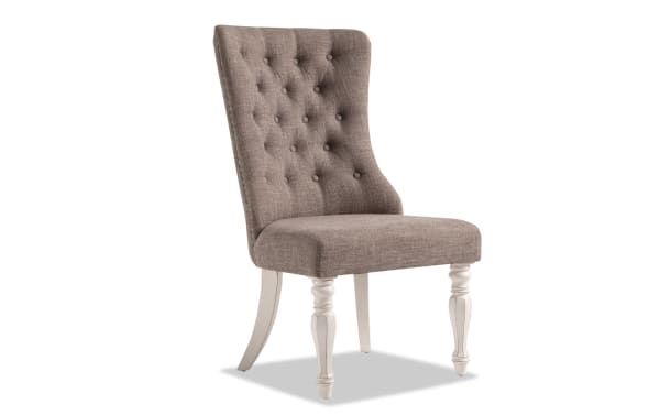 Beige Scarlett White & Beige Solid Back Upholstered Dining Chair with tufted polyester fabric, carved front legs, and distressed antique white finish.