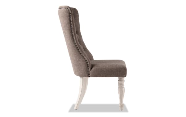Scarlett White & Beige Solid Back Upholstered Dining Chair in beige polyester fabric with tufted back, carved front legs, and distressed antique white finish, cottage style.