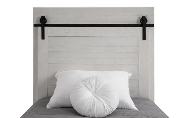 Montana Twin White Panel Storage Platform Bed in rustic pine solids and veneer, featuring a white paneled headboard with black metal sliding barn door hardware.