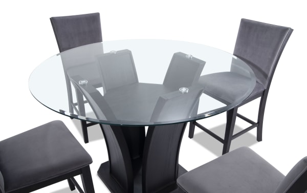 Cosmopolitan 5 Piece Black & Gray Upholstered Round Counter Height Dining Set with velvet gray fabric stools, tempered glass top, and espresso tulip base.