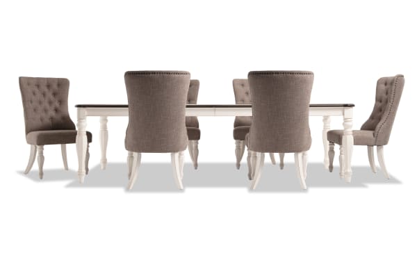 Scarlett 7 Piece Beige Upholstered Extendable Dining Set with tufted fabric polyester chairs, wire-brushed oak top, and cottage-style white carved legs.