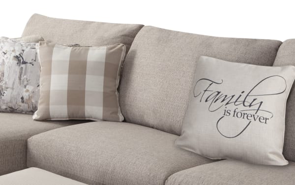 Beige Cottage Chic 4-piece right arm facing sleeper chaise sectional with soft polyester fabric, decorative pillows, and traditional nailhead accents.