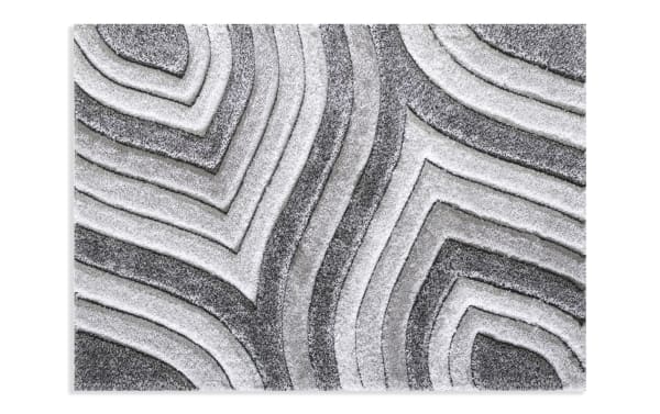 Shaggy area rug with a modern geometric pattern in varying shades of gray and white, featuring raised textured lines for a 3D effect.