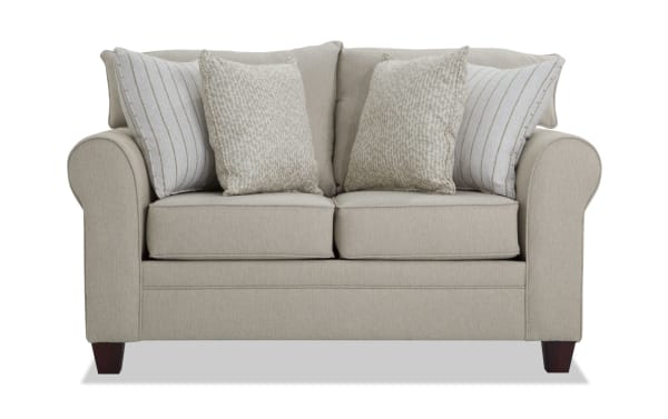 Beige Laurel 65'' transitional loveseat with rolled arms, plush Bob-O-Pedic memory foam cushions, and four patterned polyester fabric pillows.