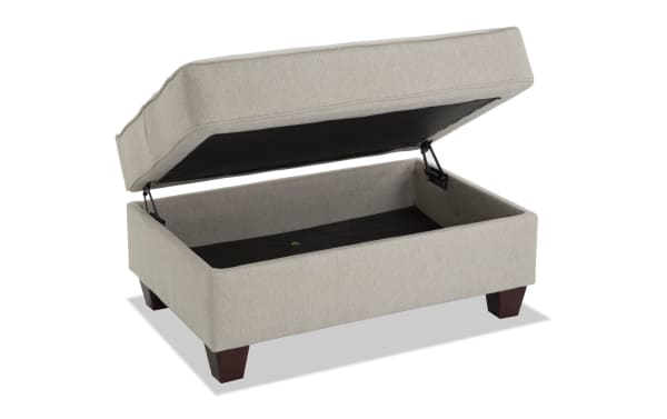 Beige Laurel Storage Ottoman with plush Bob-O-Pedic Memory Foam seating, transitional style, polyester fabric upholstery, and hidden storage compartment.