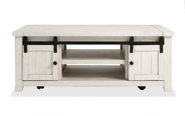 Rustic Montana White Storage Coffee Table from Montana Entertainment & Occasional collection, made of pine solids and plywood, with sliding barn doors and casters for mobility.
