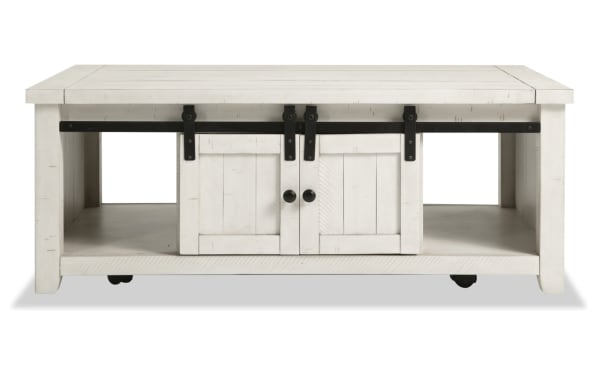 Rustic Montana White Storage Coffee Table from Montana Entertainment & Occasional collection, made of pine solids and plywood, with sliding barn doors, black hardware, and casters for mobility.