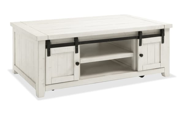 Rustic Montana White Storage Coffee Table from Montana Entertainment & Occasional collection, made of pine solids and plywood with sliding barn doors and casters for mobility.