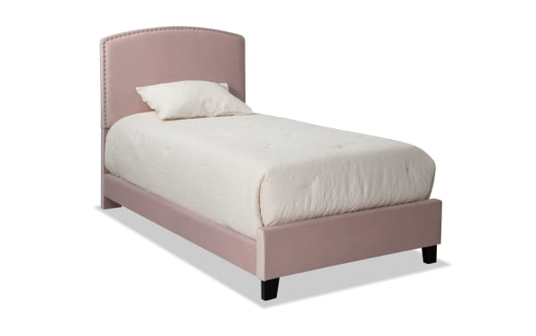 Isabella Twin Pink Upholstered Panel Bed in transitional style with pink polyester fabric, arched headboard, nailhead trim, and low footboard.