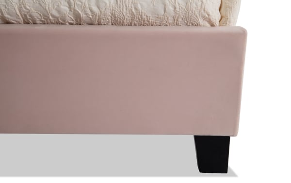 Pink Isabella Twin Upholstered Panel Bed with polyester fabric, low profile footboard, and transitional style black wooden legs.