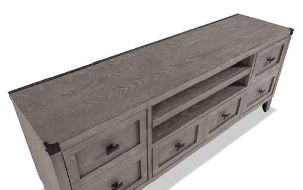 Wentworth 64'' gray transitional TV stand with poplar solid wood, MDF, metal accents, six drawers, and open center shelving for media storage.