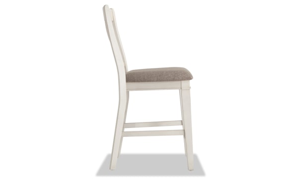 Rustic Montana Dining counter height stool in beige fabric upholstery with white rubberwood frame, slat back design, and memory foam seat cushion.
