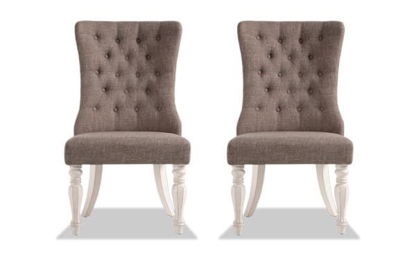 Set of 2 Scarlett White & Beige Solid Back Upholstered Dining Chairs with tufted beige polyester fabric, carved white distressed legs, cottage style.
