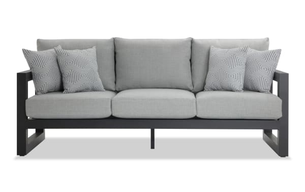Glam Gray Aluminum Outdoor Sofa with gray polyester fabric cushions, rust-free powder-coated aluminum frame, and four patterned accent pillows.
