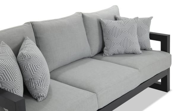 Glam Gray Aluminum Outdoor Sofa with contemporary gray polyester fabric upholstery, rust-free powder-coated aluminum frame, and four patterned accent pillows from Glam Outdoor collection.