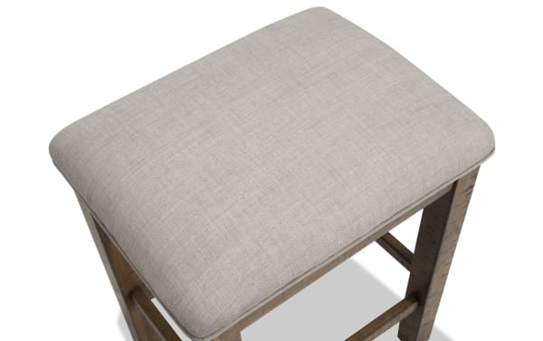 Beige upholstered backless counter height stool from Sonoma Dining, featuring a plush polyester fabric seat and solid acacia wood frame in natural finish.