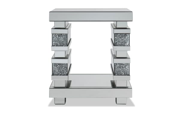 Glamour Silver Mirrored End Table from Glamour Entertainment & Occasional collection, featuring a glam style with MDF, tempered glass, beveled edges, and faux crushed crystal inlays on silver mirrored legs and open shelving for stylish living room accent.