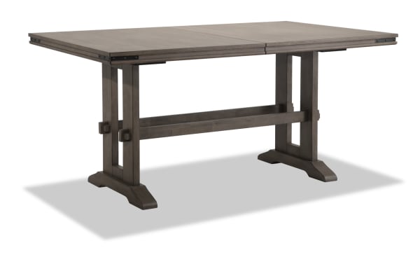 Hudson Gray Extendable Counter Height Trestle Dining Table in transitional style, wood and mango veneer with metal corner accents and two 18-inch leaves.