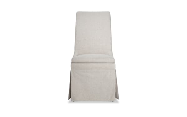 Cottage Chic Cream Solid Back Upholstered Dining Chair with polyester fabric and wood frame, skirted design, plush cushioning, farmhouse style.