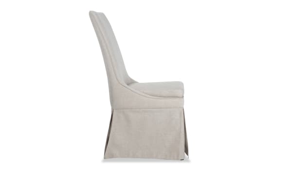 Cream solid back Cottage Chic Upholstered Dining Chair with skirted polyester fabric, wood frame, and plush web seat cushioning in farmhouse style.