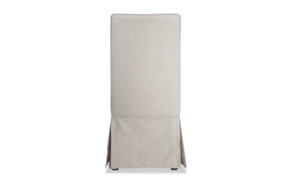 Cream solid back upholstered dining chair with skirted polyester fabric and wood frame, Cottage Chic Dining collection in farmhouse cottage style.