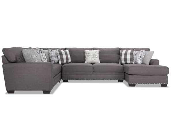 Cottage Chic gray 4-piece right arm facing sleeper chaise sectional with polyester fabric, nailhead trim, and 10+ accent pillows in traditional style.