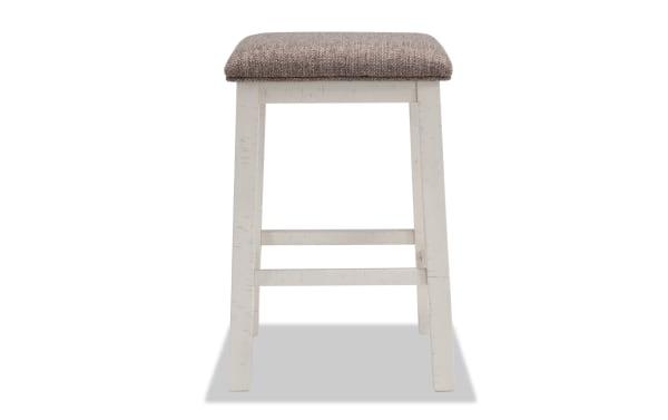 Montana White & Beige Backless Upholstered Sofa Table Stool with solid acacia frame, beige polyester fabric seat, and rustic distressed finish.