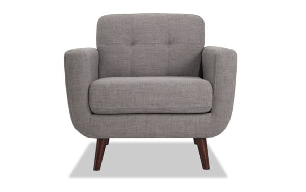 Mid-century modern Bettie Gray Chair in gray polyester fabric with tufted back, track arms, and slender flared wooden legs from Bettie collection.