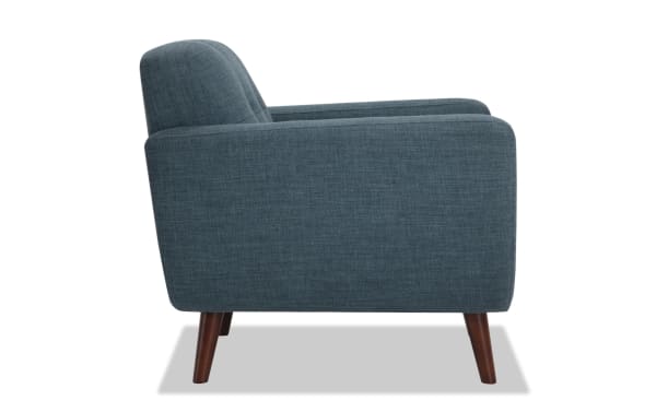 Bettie Teal Chair in mid-century modern style with teal polyester fabric upholstery, tufted seat back, track arms, and flared wooden legs.