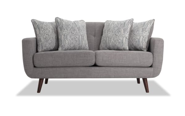 Bettie Gray 65'' Loveseat in mid-century modern style with gray polyester fabric, tufted back, four patterned accent pillows, and wooden tapered legs.