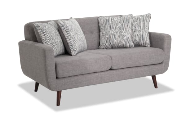 Bettie Gray 65'' Loveseat in mid-century modern style with gray 100% polyester fabric, four patterned accent pillows, track arms, and tapered wooden legs.