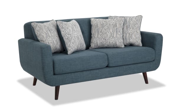 Bettie Teal 65'' Loveseat in mid-century modern style with teal 100% polyester fabric, four patterned accent pillows, track arms, and tapered wooden legs.
