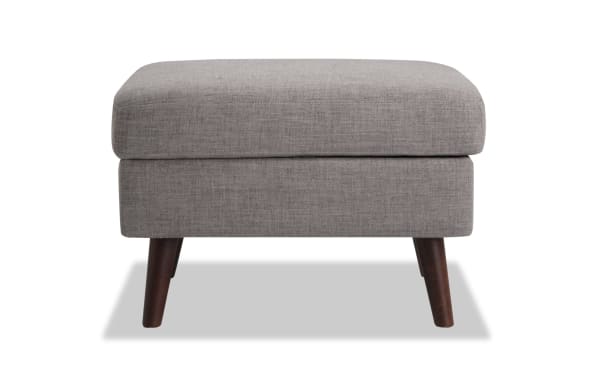Bettie Gray Storage Ottoman in mid-century modern style with gray polyester fabric upholstery, cushioned memory foam top, and wooden tapered legs.