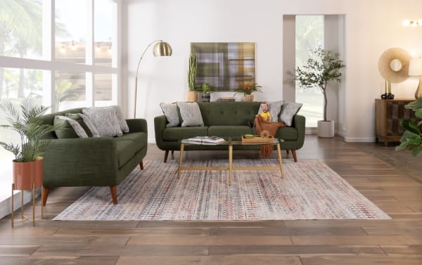 Mid-century modern Bettie Avocado 86'' sofa in green polyester fabric with tufted seat back, track arms, wooden legs, and four accent pillows.