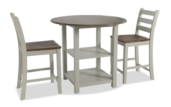 Sawyer 3 Piece Gray & Natural Drop Leaf Storage Counter Height Dining Set with MDF construction, two-tone finish, drop leaf table, two shelves, and two stools in transitional style.