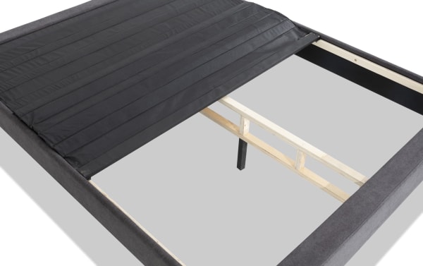 Universal King Platform Base with sturdy wooden frame and black upholstered fabric cover, designed for stable mattress support, easy assembly, and versatile use with or without legs.