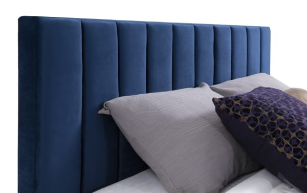 Aster Full Blue Upholstered Panel Bed with vertical tufting, soft blue polyester fabric, thick side rails, and sturdy slat base in transitional style.