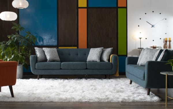 Bettie Teal 86'' Sofa & 65'' Loveseat set in mid-century modern style with teal polyester fabric, tufted backs, track arms, wooden legs, and accent pillows.