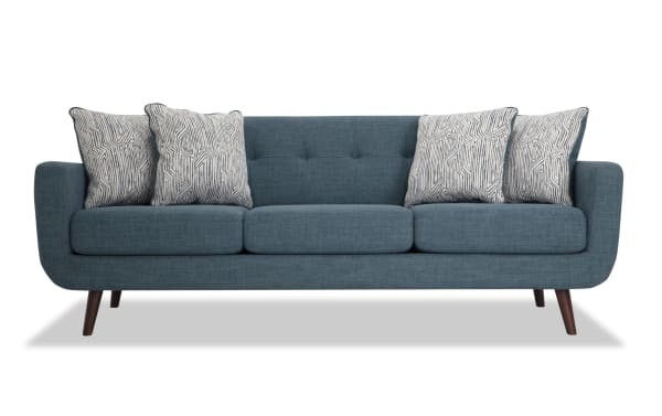 Bettie Teal 86" mid-century modern sofa with teal polyester fabric, tufted backs, track arms, wooden legs, and patterned accent pillows.