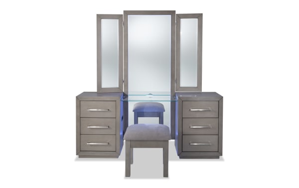 Cosmopolitan Gray 6 Drawer Vanity Set in contemporary style with solid acacia, LED-lit tri-fold mirrors, silver hardware, glass shelf, power outlets, USB ports, felt-lined drawers, and cushioned stool.