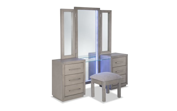 Cosmopolitan Gray 6 Drawer Vanity Set with LED-lit tri-fold mirror, solid Acacia wood, gray finish, silver hardware, glass shelf, USB ports, and cushioned stool.