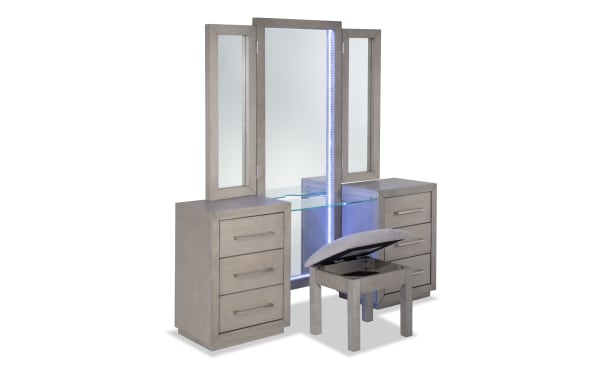 Cosmopolitan Gray 6 Drawer Vanity Set with LED-lit tri-fold mirror, solid acacia wood, gray finish, silver hardware, glass shelf, USB ports, and cushioned stool.