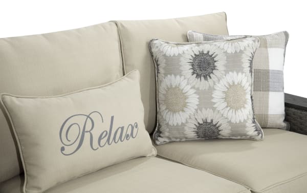 Cottage Chic Beige Wicker Outdoor Sofa with beige powder-coated aluminum frame, weather-resistant polyester cushions, and decorative floral and plaid accent pillows.