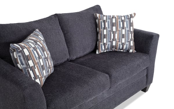 Stevie Charcoal 65'' Loveseat in gray polyester fabric with transitional style, flair arms, oversized seating, and patterned accent pillows.