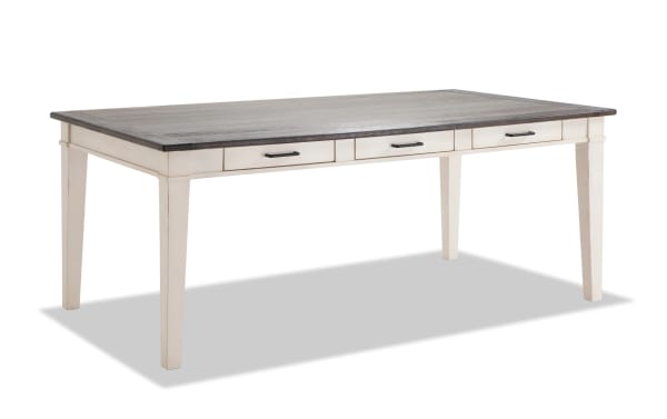 Rustic Montana 9 Piece Dining Table with distressed oak veneer top, beige rubberwood base, and six black-handled storage drawers.