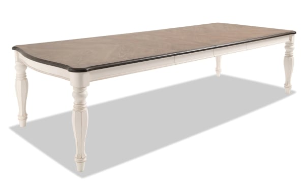 Scarlett extendable dining table in cottage style with beige wire brushed oak veneer top, carved white poplar legs, and antique finish.
