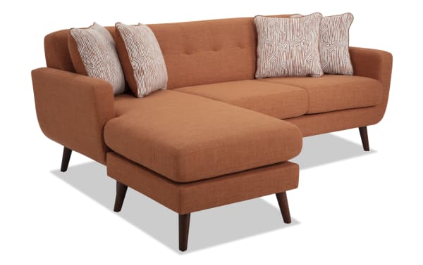 Bettie Russet 86'' Chofa mid-century modern sectional sofa in orange polyester fabric with movable chaise, four patterned accent pillows, tufted seat back, and wooden tapered legs.