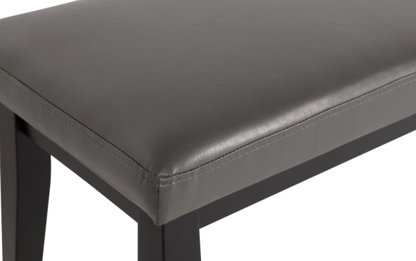 Gray faux leather dining bench from the Elm Dining collection, featuring foam-padded seat and sturdy MDF legs in transitional style.