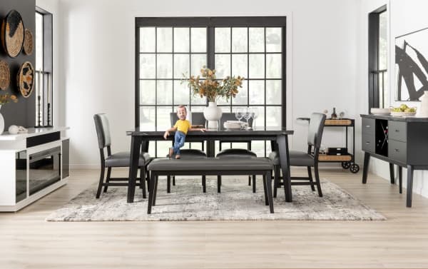 Transitional Elm Dining set with gray faux leather panel back upholstered chairs and bench, MDF frame, black wood table, and neutral decor.