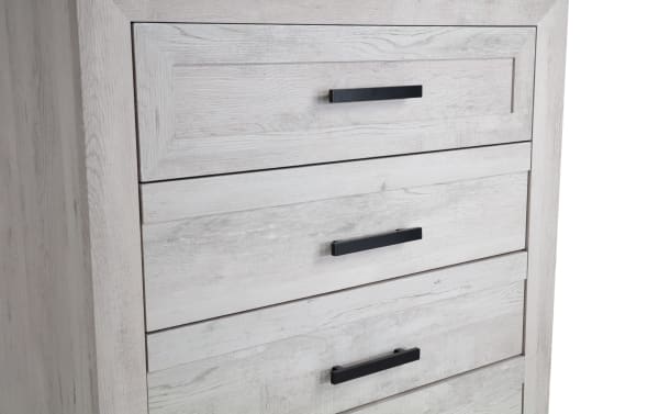 Calvin White 5 Drawer Chest in engineered wood grain with black handles, featuring a contemporary plank-style design for bedroom storage.